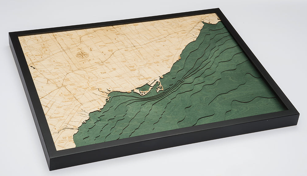 Toronto, Ontario 3D layered wood map in laser-cut Baltic birch, shown framed against a light wall