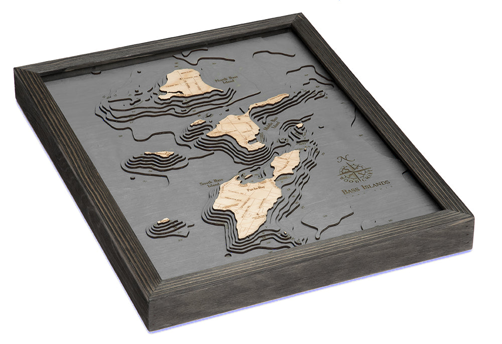 Put-in-Bay, Ohio 3D layered wood map in laser-cut Baltic birch, shown framed against a light wall