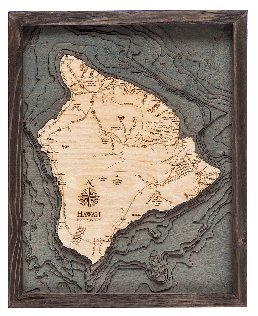 The Big Island, Hawaii 3D layered wood map in laser-cut Baltic birch, shown framed against a light wall