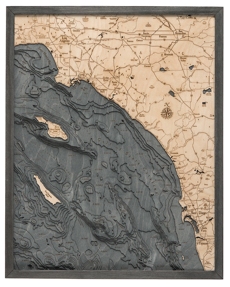 LA to San Diego, California 3D layered wood map in laser-cut Baltic birch, shown framed against a light wall