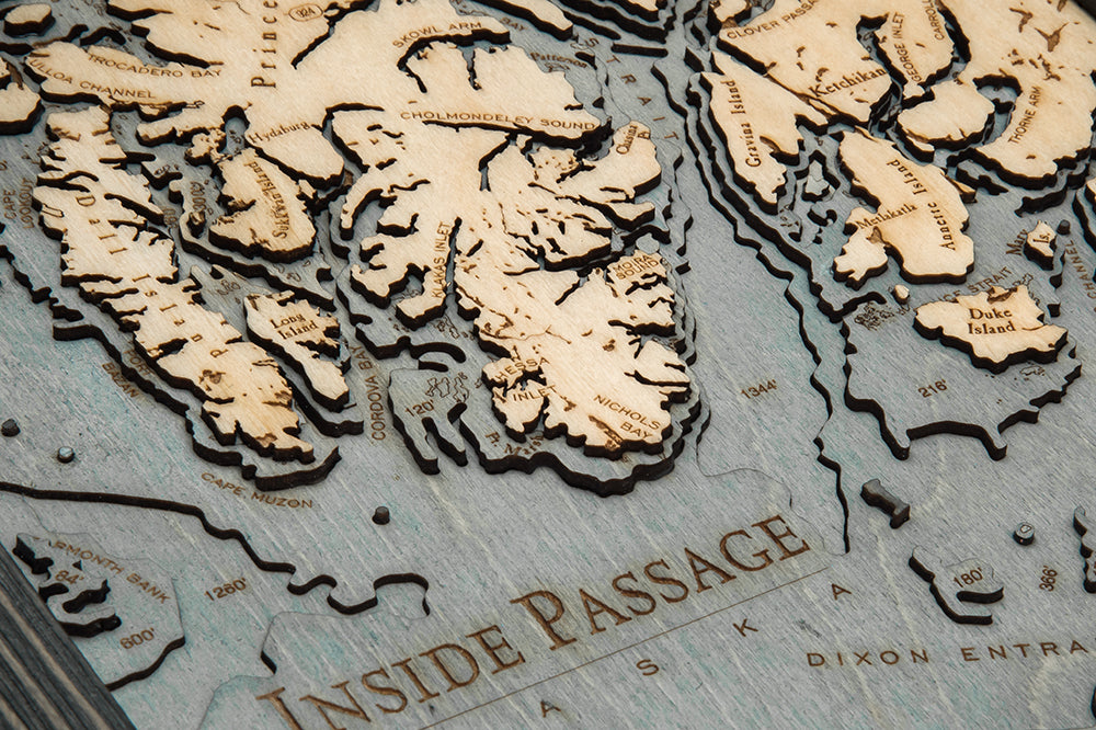 Inside Passage, Alaska 3D layered wood map in laser-cut Baltic birch, shown framed against a light wall