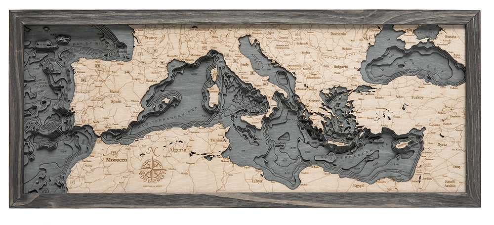 Mediterranean Sea 3D layered wood map in laser-cut Baltic birch, shown framed against a light wall