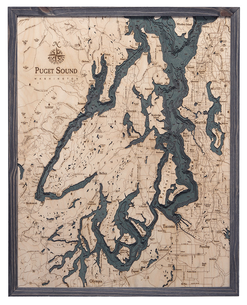 Puget Sound, Washington 3D layered wood map in laser-cut Baltic birch, shown framed against a light wall