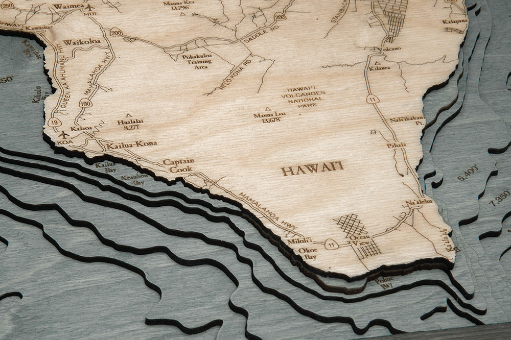 Hawaiian Islands 3D layered wood map in laser-cut Baltic birch, shown framed against a light wall