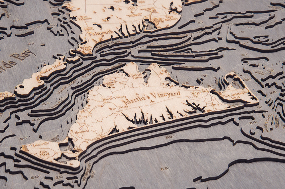Cape Cod, Massachusetts 3D layered wood map in laser-cut Baltic birch, shown framed against a light wall