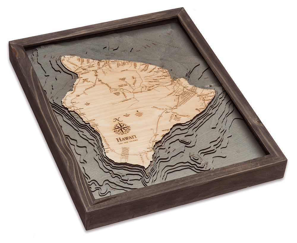 The Big Island, Hawaii 3D layered wood map in laser-cut Baltic birch, shown framed against a light wall