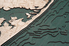 Rumson, New Jersey 3D layered wood map in laser-cut Baltic birch, shown framed against a light wall