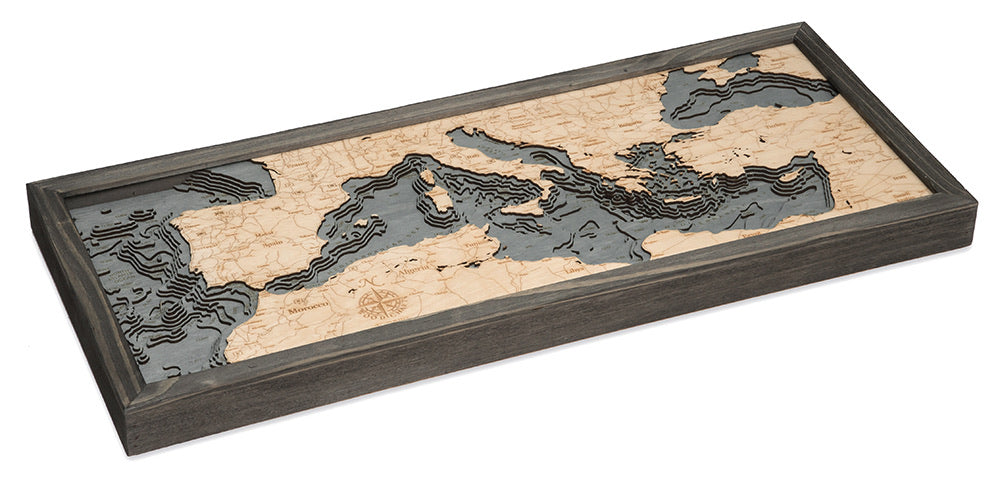 Mediterranean Sea 3D layered wood map in laser-cut Baltic birch, shown framed against a light wall