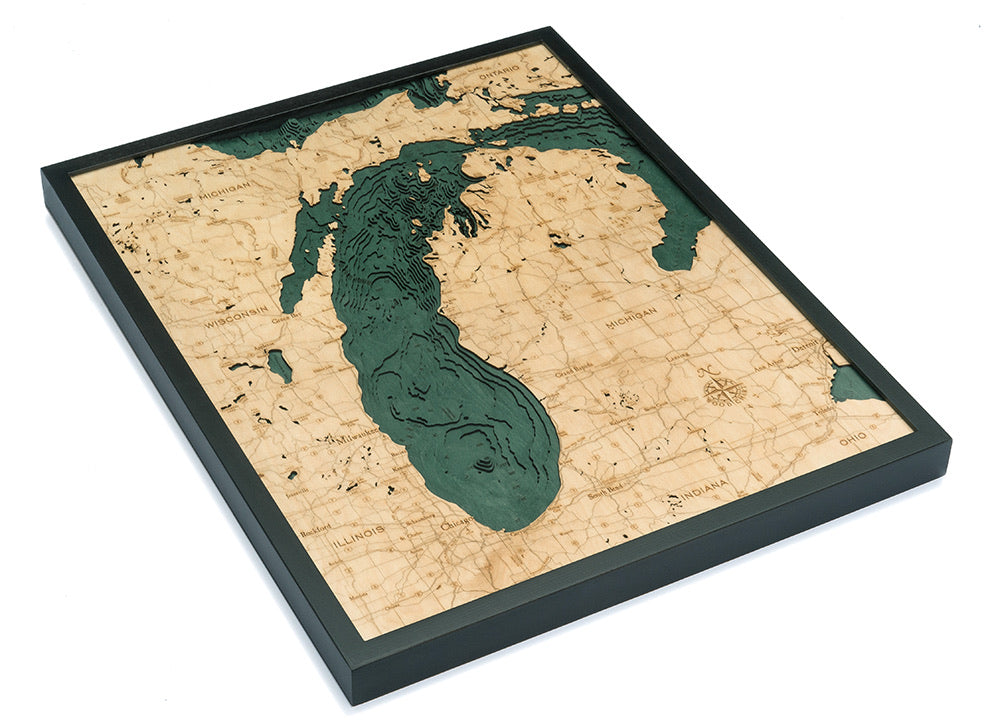Lake Michigan 3D layered wood map in laser-cut Baltic birch, shown framed against a light wall