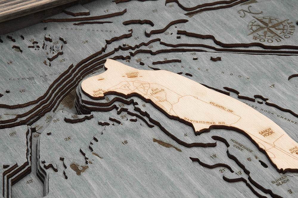 Rumson, New Jersey 3D layered wood map in laser-cut Baltic birch, shown framed against a light wall